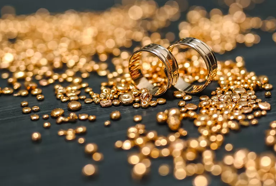 Gold ring set within a small pile of gold grain