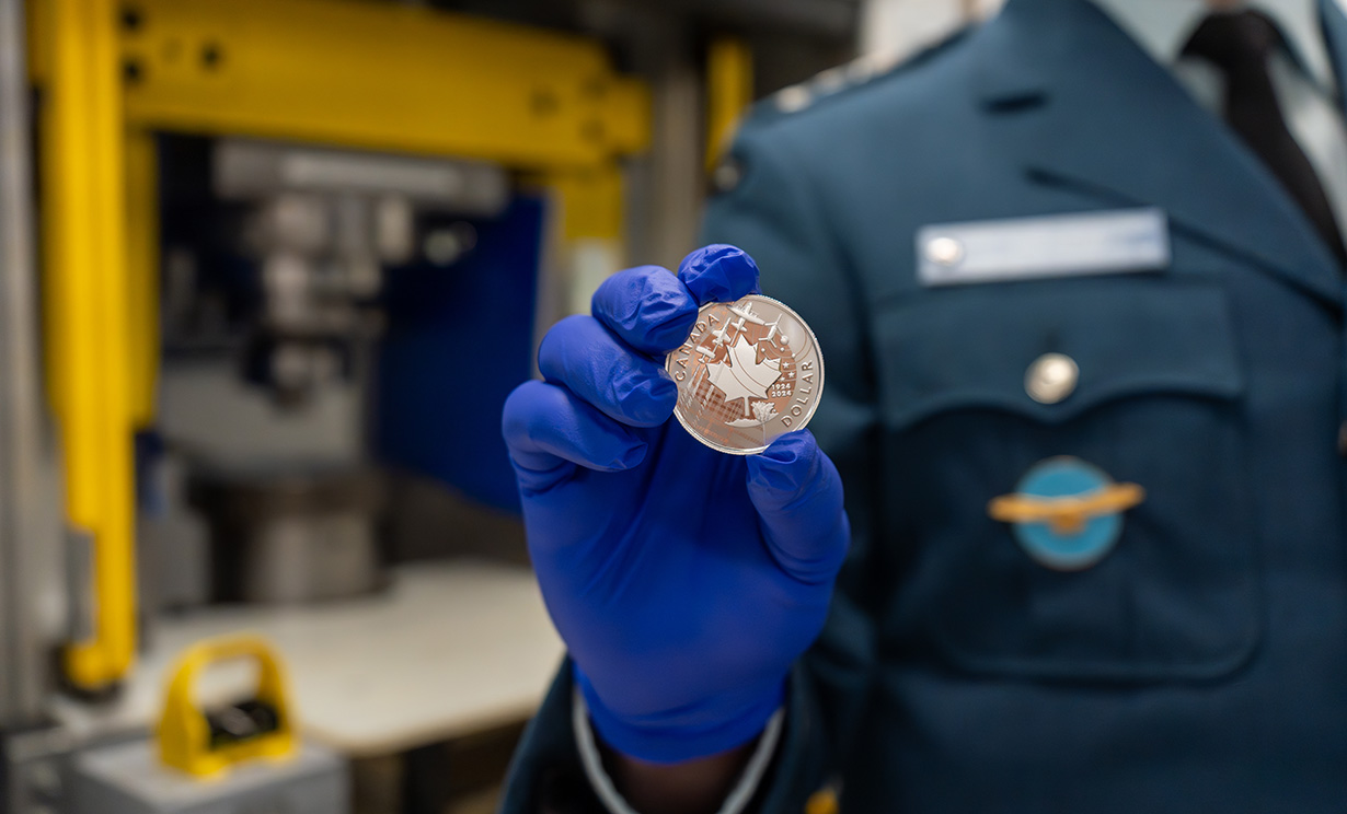 image Lieutenant-General Eric Kenny holds RCAF Centennial Proof Dollar