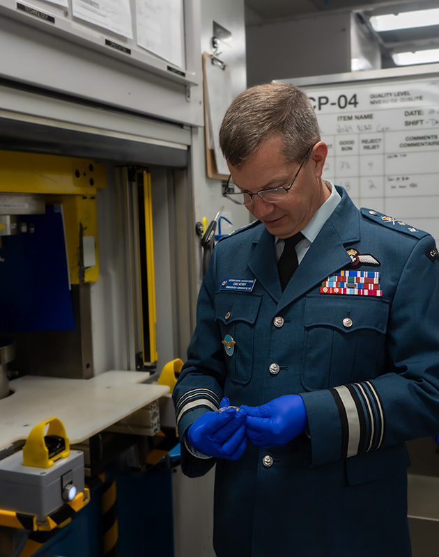 image Lieutenant-General Eric Kenny striking coin